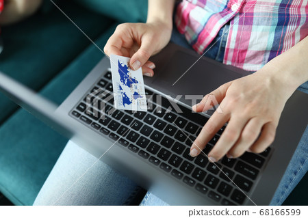 Female hands holding a credit card close up Female hands holding a credit card close up 68166599