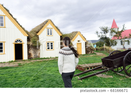Iceland Tourist by Old Farmhouse Laufas Glaumbaer farm Museum turf roof house Iceland Tourist by Old Farmhouse Laufas Glaumbaer farm Museum turf roof house 68166671