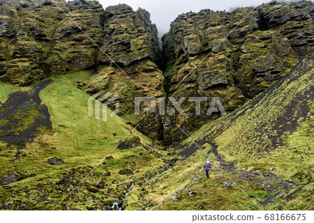 Iceland hiker tourist sightseeing visiting Raudfeldsgja Canyon gorge rift nature landscape on the Snaefellsnes peninsula, West Iceland Iceland hiker tourist sightseeing visiting Raudfeldsgja Canyon gorge rift nature landscape on the Snaefellsnes peninsula, West Iceland 68166675