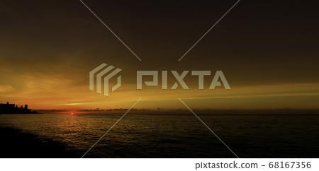 Sunset over Malecon and Atlantic Ocean with residential building in background - Havana, Cuba 68167356