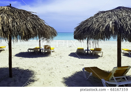 Cuban beach, umbrellas and sunbeds with Atlantic Ocean in background - Varadero, Cuba  68167359