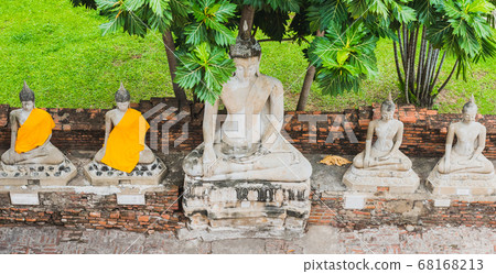 Row of Buddhas under breadfruit tree. Medieval Buddhist temple Wat Yai Chai Mongkhon (Wat Yai Chaimongkol) in Ayutthaya City, a day trip travel destination from Bangkok. 68168213