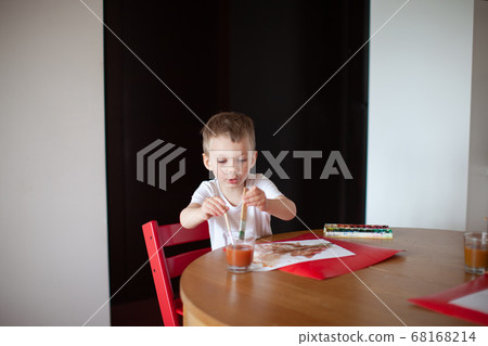 Three year old boy paint with watercolor at home.  68168214