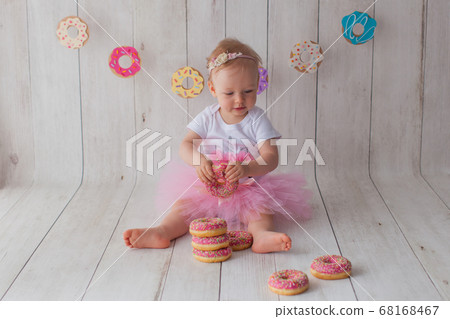 One year old baby girl celebrates her birthday. One year old baby girl celebrates her birthday. 68168467