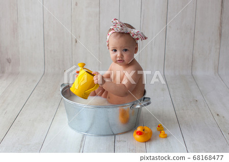 Little baby takes a bath. 68168477