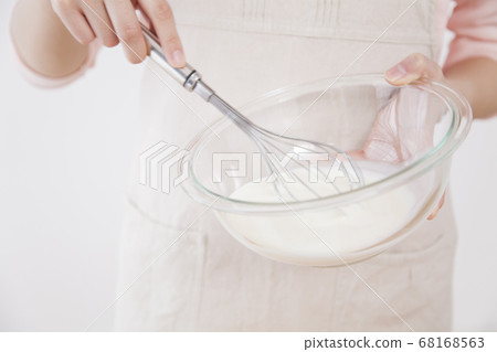 Woman mixing whipped cream Woman mixing whipped cream 68168563