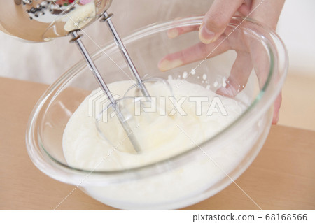 Woman mixing whipped cream Woman mixing whipped cream 68168566