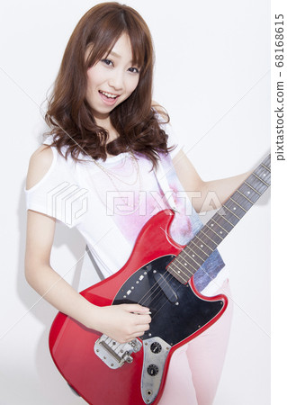 Woman playing guitar Woman playing guitar 68168615