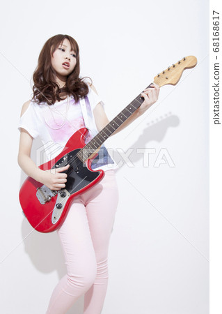 Woman playing guitar Woman playing guitar 68168617