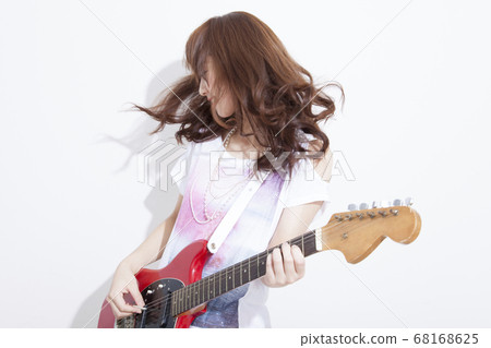 Woman playing guitar 68168625