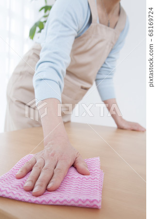 Housewife wiping the table Housewife wiping the table 68169724