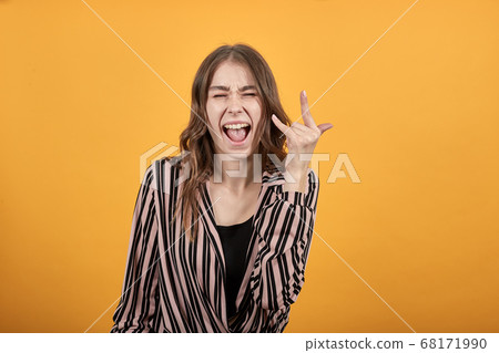 Expressive Emotional Girl Shows Her Fingers The Rock Sign Expressive Emotional Girl Shows Her Fingers The Rock Sign 68171990
