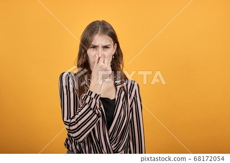 girl covered her nose with hand in disgust from the bad smell girl covered her nose with hand in disgust from the bad smell 68172054