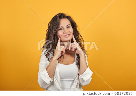 Hold arms hands cheeks cheekbones overjoyed palms touch chin charming smile. 68172055