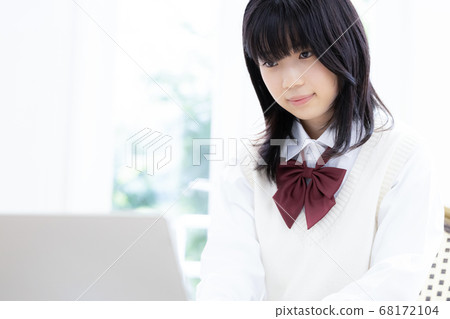 Female high school student studying on tablet Female high school student studying on tablet 68172104