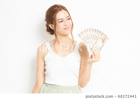 Young woman holding money Young woman holding money 68172441