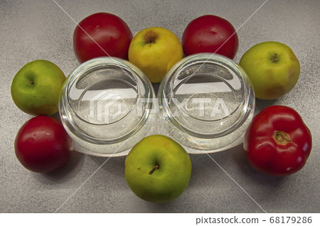 photo apples green and red tomatoes with two glasses on gray background photo apples green and red tomatoes with two glasses on gray background 68179286