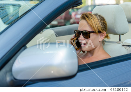 Woman driving a car Woman driving a car 68180122