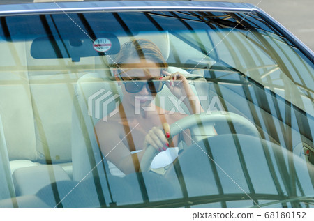 Woman driving a car Woman driving a car 68180152