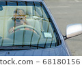 Woman driving a car 68180156