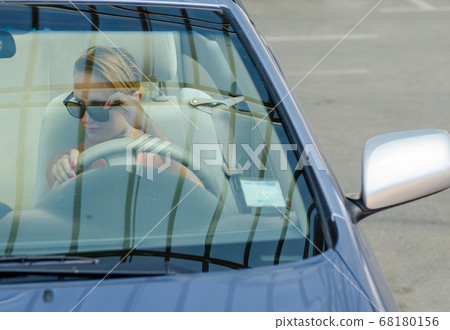 Woman driving a car Woman driving a car 68180156