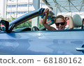 Woman driving a car 68180162