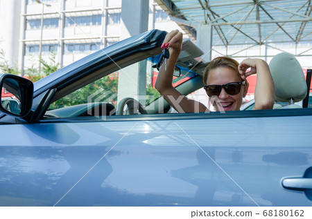 Woman driving a car Woman driving a car 68180162