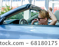 Woman driving a car 68180175