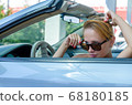 Woman driving a car 68180185
