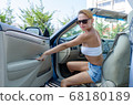 Woman driving a car 68180189