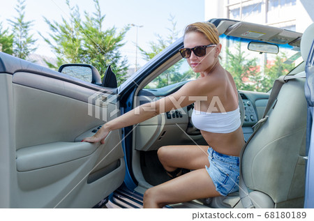 Woman driving a car Woman driving a car 68180189