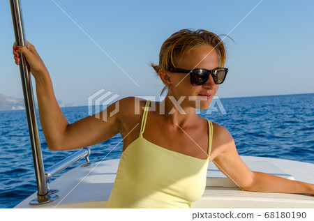 Red woman on a yacht cruise Red woman on a yacht cruise 68180190