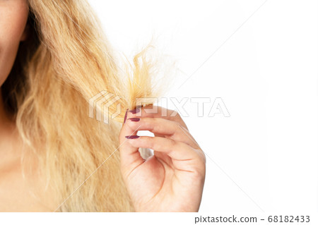 Young woman holding hair, decide to hair care Young woman holding hair, decide to hair care 68182433