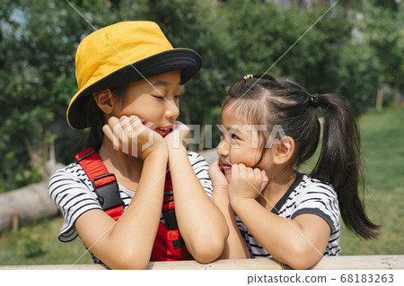 Close up playful asian girl sitting on the bench. 68183263