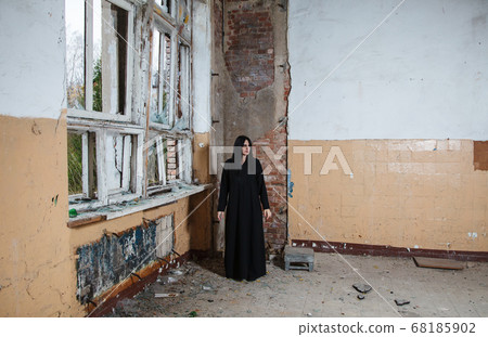 young goth woman stands in the room of an young goth woman stands in the room of an 68185902