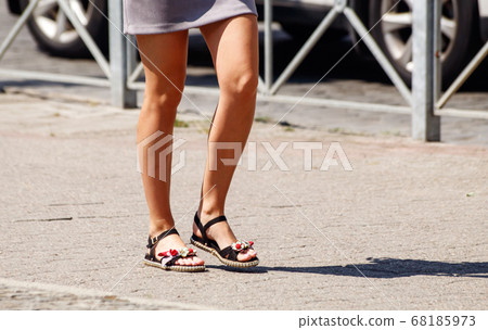 young woman walking on the sidewalk young woman walking on the sidewalk 68185973