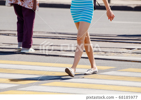 young woman crossing the road at a pedestrian young woman crossing the road at a pedestrian 68185977