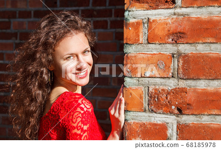 portrait of a young brunette girl in a red dress portrait of a young brunette girl in a red dress 68185978