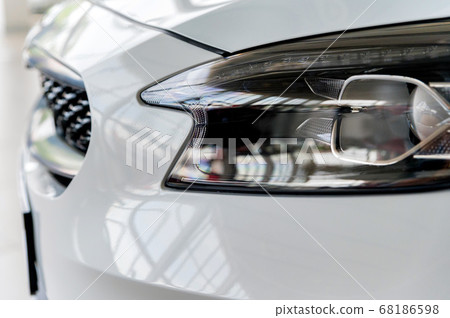 Close-up image of headlights of white modern car Close-up image of headlights of white modern car 68186598