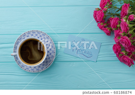 Cup of coffee with bouquet of rose flowers. Cup of coffee with bouquet of rose flowers. 68186874