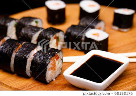 Sushi with salmon. Soy sauce, red caviar. Sushi on a black background. Sushi with salmon. Soy sauce, red caviar. Sushi on a black background. 68188176