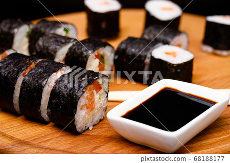 Sushi with salmon. Soy sauce, red caviar. Sushi on a black background. 68188177