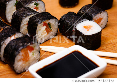Sushi with salmon. Soy sauce, red caviar. Sushi on a black background. Sushi with salmon. Soy sauce, red caviar. Sushi on a black background. 68188178