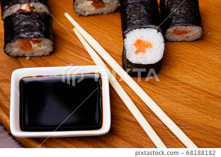 Sushi with salmon. Soy sauce, red caviar. Sushi on a black background. Sushi with salmon. Soy sauce, red caviar. Sushi on a black background. 68188182