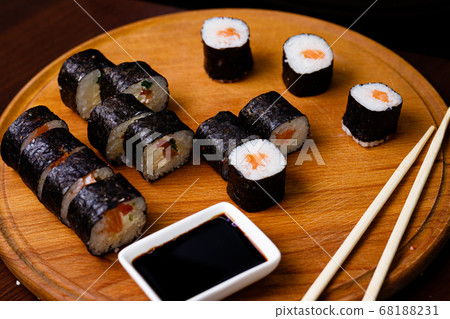 Sushi with salmon. Soy sauce, red caviar. Sushi on a black background. Sushi with salmon. Soy sauce, red caviar. Sushi on a black background. 68188231