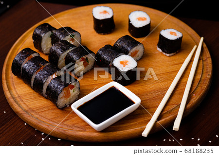 Sushi with salmon. Soy sauce, red caviar. Sushi on a black background. Sushi with salmon. Soy sauce, red caviar. Sushi on a black background. 68188235