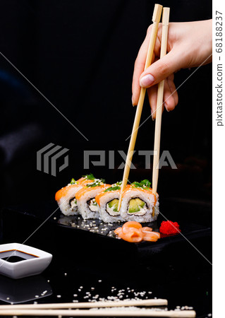Sushi with salmon. Soy sauce, red caviar. Sushi on a black background. Sushi with salmon. Soy sauce, red caviar. Sushi on a black background. 68188237