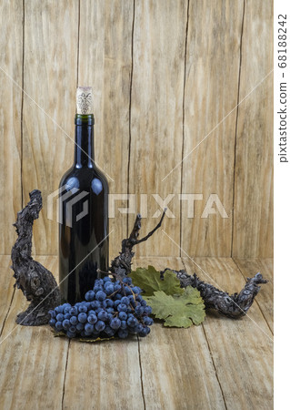 black grapes with a vine and a glass of wine and a bottle black grapes with a vine and a glass of wine and a bottle 68188242