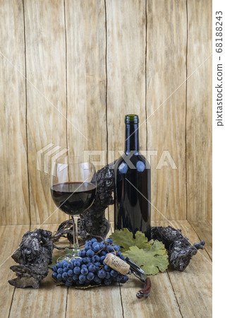 black grapes with a vine and a glass of wine and a bottle black grapes with a vine and a glass of wine and a bottle 68188243