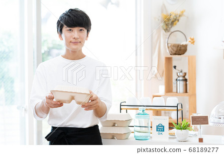 A man working as a cafe clerk [takeout] 68189277